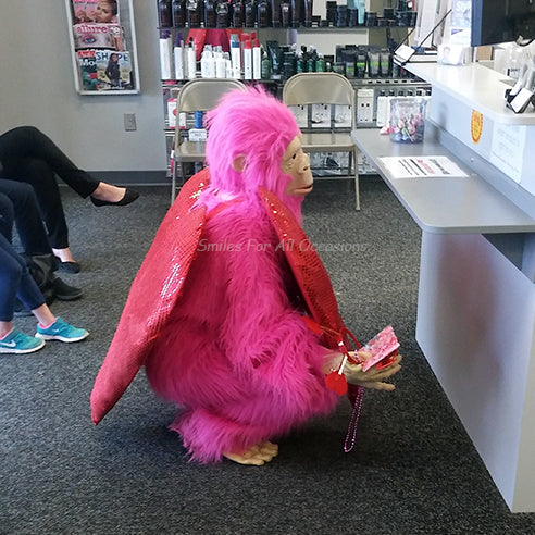 Pink Gorilla with Large Red Heart on Chest Hiding Behind Counter
