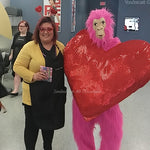 Pink Gorilla with Large Red Heart on Chest Standing with a Woman