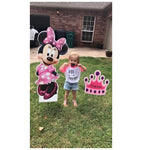 Little Girl Standing Next To Minnie Mouse and Princess Crown Yard Signs