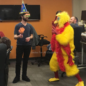 Yellow Chicken with Red Boa Singing to Man with Birthday Hat